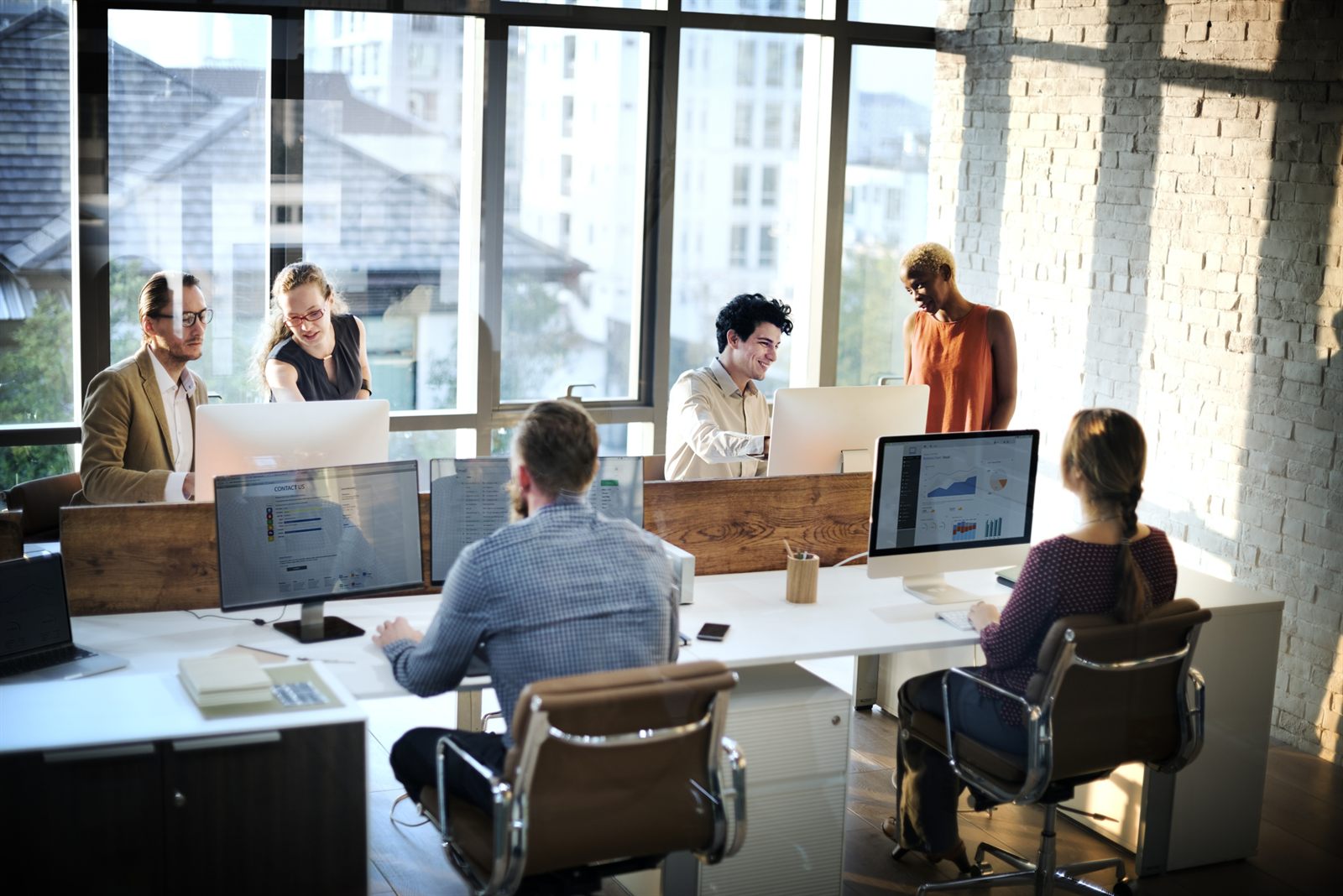 Bright open workspace with professionals at computers